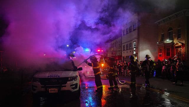 The New York Fire Department helps put out a vehicle fire in Brooklyn on 30 May. By Chang W Lee © 2020 The New York Times