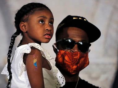 Former NBA star Stephen Jackson holds Gianna Floyd (the daughter of George Floyd) on Tuesday during a news conference. AP Photo