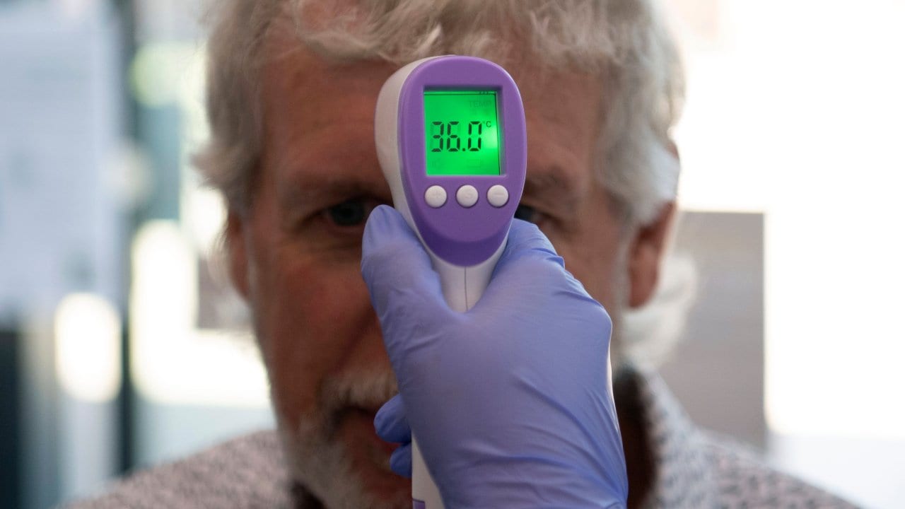 A patient has his temperature taken with a non-contact infrared thermometer on arrival at Freshney Green Primary Care Centre in Grimsby, England on 9 June 2020. Image: AP/AFP