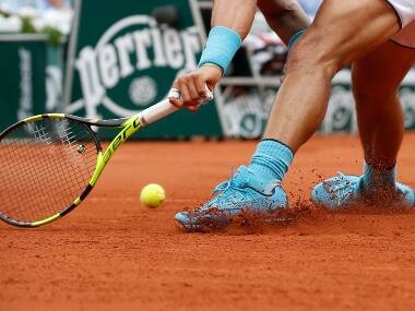 Spain’s Rafael Nadal runs and slides to return a shot during the French Open. AP