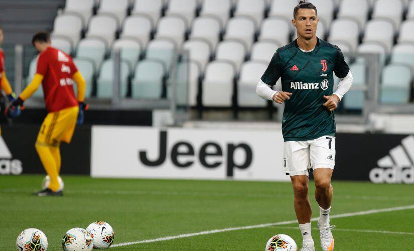 Juventus' Cristiano Ronaldo warms-up before the Italian Cup second leg soccer match between Juventus and AC Milan at the Allianz stadium, in Turin, Italy, Friday, June 12, 2020. (AP Photo/Luca Bruno)