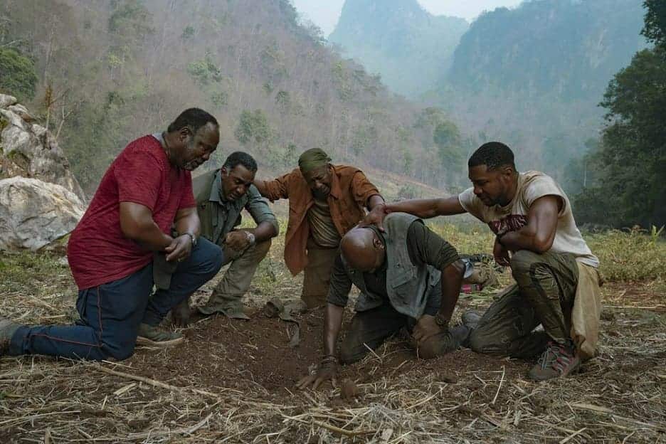This image released by Netflix shows, from left, Isiah Whitlock Jr., Norm Lewis, Clarke Peters, Delroy Lindo and Jonathan Majors in a scene from the Spike Lee film 