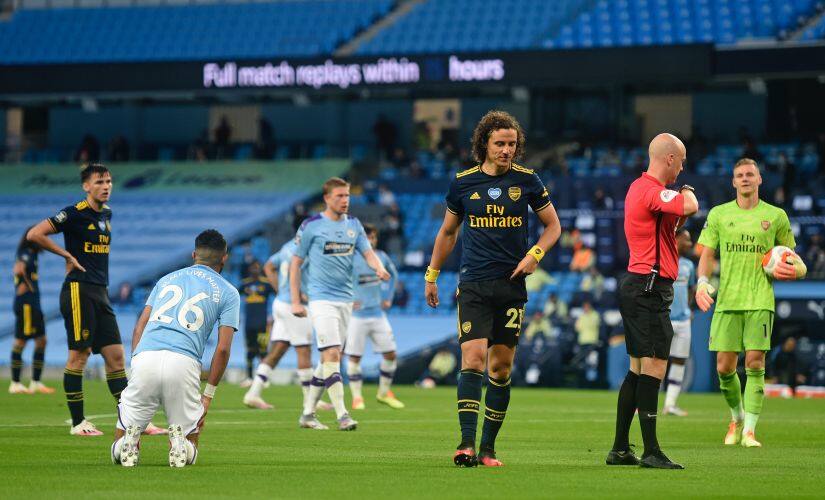 Arsenal's David Luiz leaves the field after getting a red card during the English Premier League soccer match between Manchester City and Arsenal at the Etihad Stadium in Manchester, England, Wednesday, June 17, 2020. The English Premier League resumes Wednesday after its three-month suspension because of the coronavirus outbreak. (Peter Powell/Pool via AP)