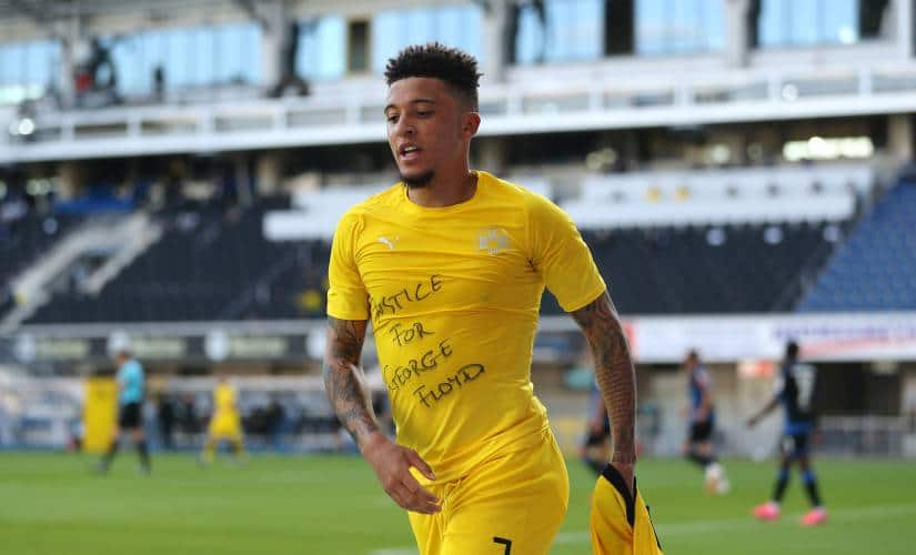 PADERBORN, GERMANY - MAY 31: Jadon Sancho of Borussia Dortmund celebrates scoring his teams second goal of the game with a 'Justice for George Floyd' shirt during the Bundesliga match between SC Paderborn 07 and Borussia Dortmund at Benteler Arena on May 31, 2020 in Paderborn, Germany. (Photo by Lars Baron/Getty Images)