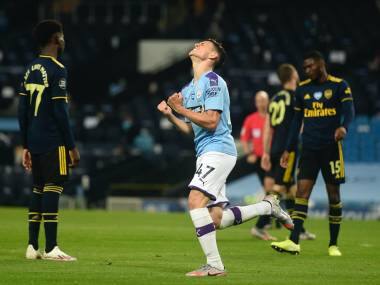 Manchester City's Phil Foden celebrates scoring his side's third goal during the English Premier League soccer match between Manchester City and Arsenal at the Etihad Stadium in Manchester, England, Wednesday, June 17, 2020. The English Premier League resumes Wednesday after its three-month suspension because of the coronavirus outbreak. (Peter Powell/Pool via AP)