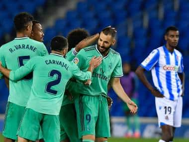 Real Madrid's Karim Benzema celebrates his goal during the Spanish La Liga soccer match between Real Sociedad and Real Madrid at Anoeta stadium, San Sebastian, Spain, Sunday, June 21, 2020. (AP Photo/Alvaro Barrientos)