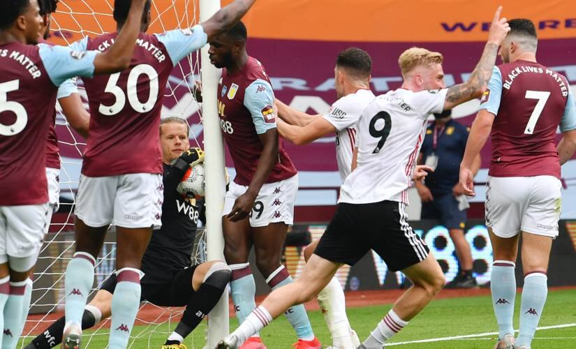Aston Villa's Oerjan Nyland saves inside the net during the English Premier League soccer match between Aston Villa and Sheffield United at Villa Park in Birmingham, England, Wednesday, June 17, 2020. The English Premier League resumes Wednesday after its three-month suspension because of the coronavirus outbreak. (Paul Ellis/Pool via AP)