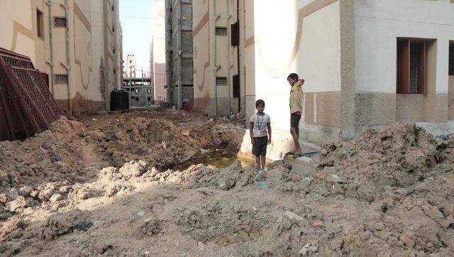Vijay Vasanth says when his family was first moved to Perumbakkam, there was no electricity or running water. Some residents report sleeping outside due to unfinished apartments, or carrying water multiple stories due to elevator outages. Image via Undark/ Ganesh Kumar
