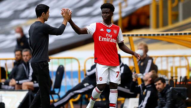 Arsenal's Bukayo Saka with Arsenal's head coach Mikel Arteta after being substituted during their Premier League match against Wolves. AP