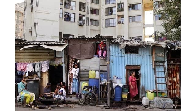 File photo: People rest by their shanties at Dharavi, one of Asia's largest slums, during lockdown to prevent the spread of the coronavirus in Mumbai. Dharavi was among Mumbai’s most affected pockets (AP/Rajanish Kakade)