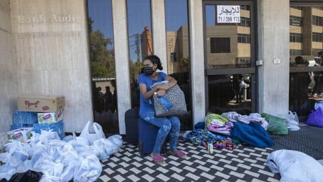 An Ethiopian domestic worker waits in front of the Ethiopian consulate after she and others were abandoned by their Lebanese employers, in Hazmieh, east of Beirut, Lebanon, Thursday, June 4, 2020. On Wednesday night, dozens of Ethiopian workers abandoned by their employers were transported to a hotel by the Labor Ministry where they could stay until they can be flown out of the country, after chaotic scenes outside the consulate. Image via The Associated Press/ Hassan Ammar