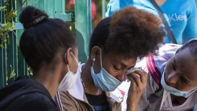 An Ethiopian domestic worker cries as she waits with dozens of others outside the Ethiopian consulate, some inquiring about flights home, others stranded after they were abandoned by employers who claimed they could no longer afford to pay their salaries, in Hazmieh, east of Beirut, Lebanon, Thursday, June 4, 2020. Some 180,000 domestic workers in Lebanon, most of them female from Ethiopia, are growing more desperate as a crippling economic and financial crisis sets in, coupled with coronavirus restrictions. (AP Photo/Hassan Ammar)