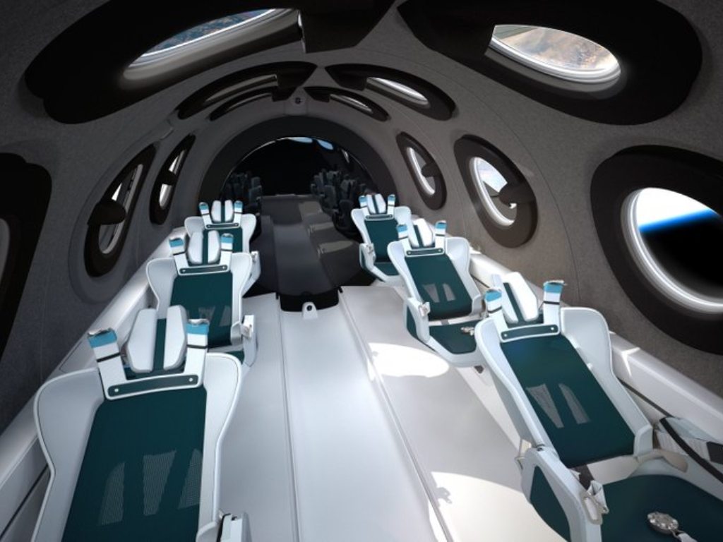 Virgin Galactic shows the interior of their SpaceshipTwo Cabin during a flight. Highly detailed amenities to enhance the customer experience were shown in an online event Tuesday, July 28, 2020, revealing the cabin of the company's rocket plane, a type called SpaceShipTwo, which is undergoing testing in preparation for commercial service. There are a dozen windows for viewing, seats capable of being customized to each of six passengers and mood lighting. Image credit: twitter/virgin galactic