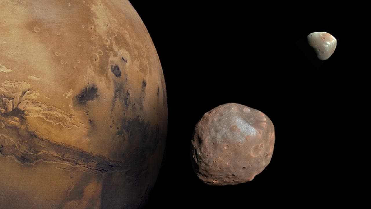 Mars along its moons Phobos and Deimos.  