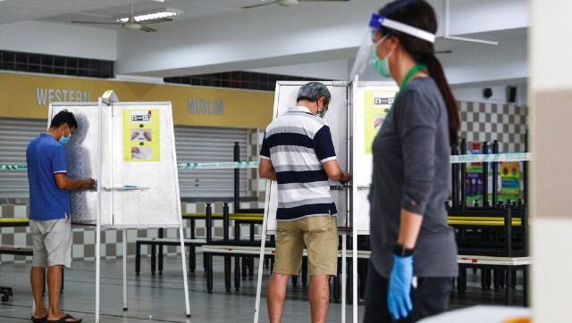 Election officials wore full protective gear and polling booths were sanitized every half hour. AP