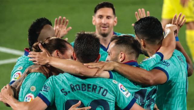 FC Barcelona players celebrate their opening goal during the Spanish La Liga soccer match between FC Barcelona and Villareal at La Ceramica stadium in Villareal, Spain, Sunday, July 5, 2020. (AP Photo/Jose Miguel Fernandez de Velasco)