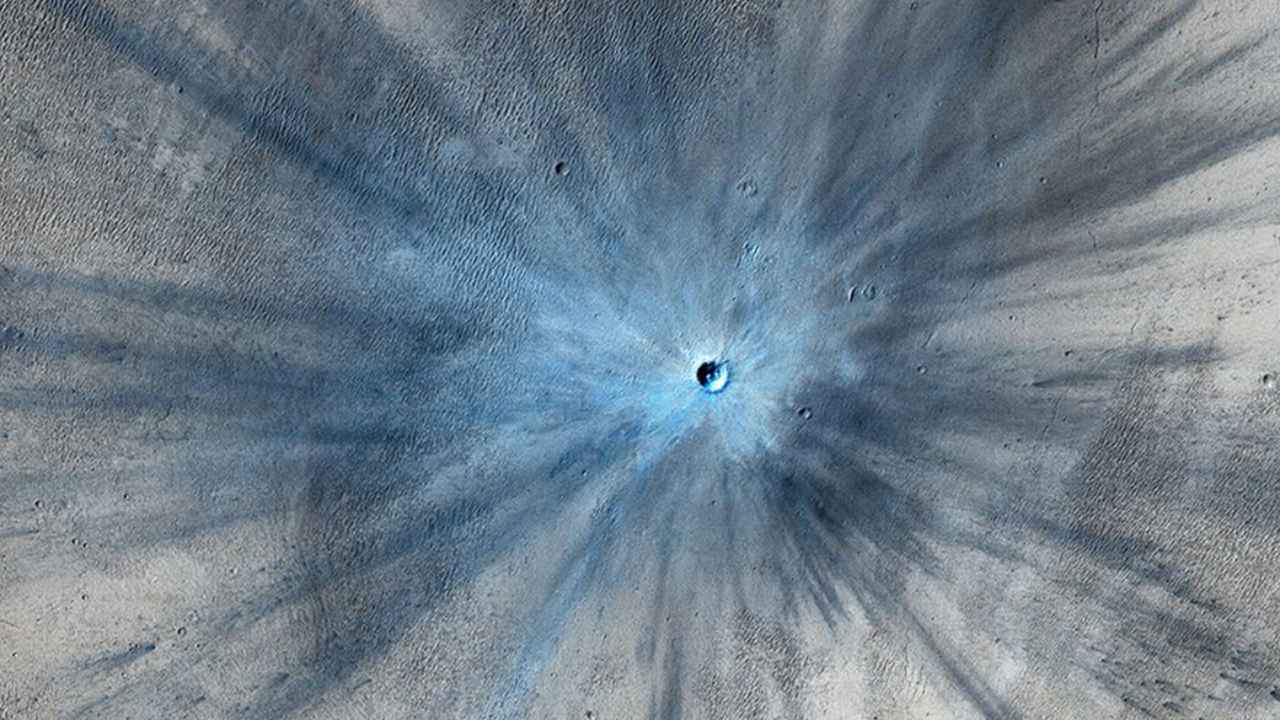 A dramatic, fresh impact crater dominates this image taken by the High Resolution Imaging Science Experiment (HiRISE) camera on NASA's Mars Reconnaissance Orbiter on Nov. 19, 2013. Researchers used HiRISE to examine this site because the orbiter's Context Camera had revealed a change in appearance here between observations in July 2010 and May 2012, bracketing the formation of the crater between those observations. Image credit: NASA/JPL-Caltech/Univ. of Arizona