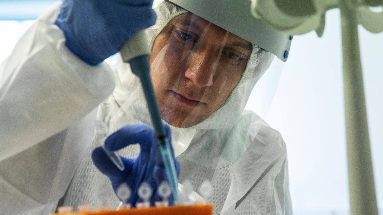 A medical worker performs a COVID-19 test at a test center at Vnukovo airport outside Moscow, Russia, Friday, Aug. 7, 2020. Authorities in Russia say they are about to approve a COVID-19 vaccine, with mass vaccinations planned as early as October 2020, using shots that are yet to complete clinical trials. But scientists worldwide are sounding the alarm that the headlong rush could backfire and point to ethical issues that undermine confidence in the Russian studies. (AP Photo/Pavel Golovkin)
