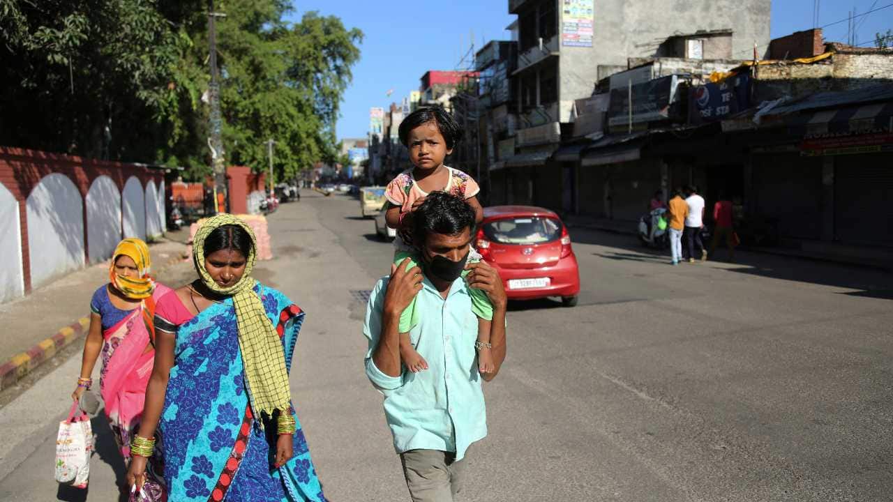 Indian laborers walk closed marketduring reimposed weekend lockdown to prevent the spread of coronavirus in Jammu, India Saturday, Aug.22, 2020.India has the third-highest caseload after the United States and Brazil, and the fourth-highest death toll in the world.(AP Photo/Channi Anand)