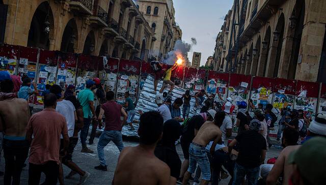 Protesters outside the Lebanese Parliament in downtown Beirut on Monday. By Diego Ibarra Sanchez © 2020 The New York Times