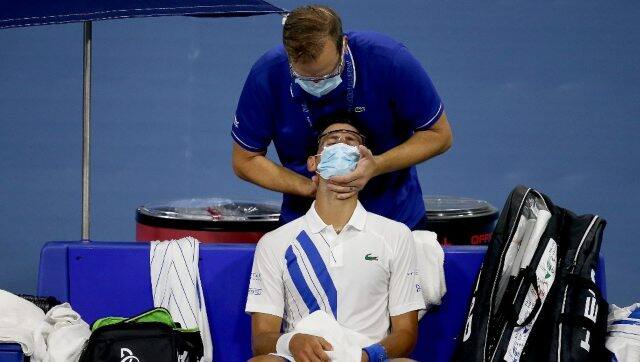 Novak Djokovic receiving treatment for neck pain during his match at Western & Southern Open. AFP