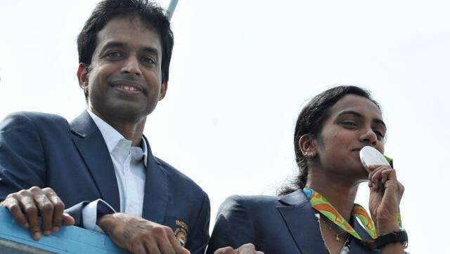 PV Sindhu (R) and her coach P. Gopichand duirng an open-top bus parade in 2016 after arriving in Hyderabad from the Rio Olympics. PTI