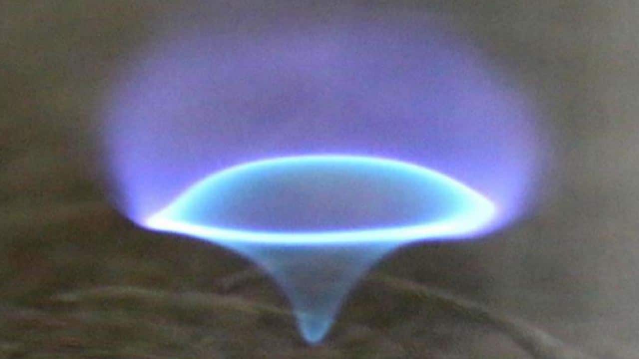 This unusual spinning flame, called a blue whirl, is made up of four different types of flames, researchers report. Image: Uni of Wisconsin