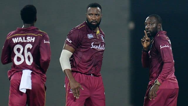 Kesrick Williams (R) celebrates the wicket of Virat Kohli at Thiruvananthapuram. AFP