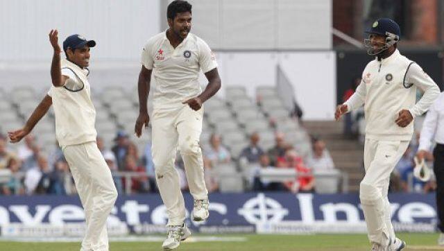 Varun Aaron (C) celebrates taking the wicket of Moeen Ali IN 2014 Manchester Test. AFP