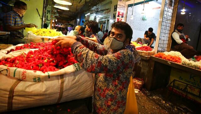Vendors arrange flowers at a wholesale flower market ahead of the Hindu festival of Dussehra, in Bengaluru. AP