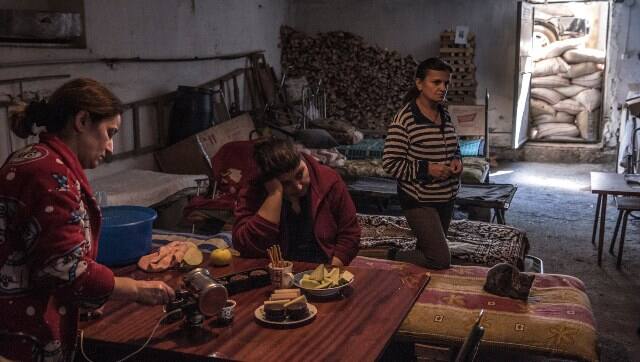 Residents prepare food as they shelter in the basement of an apartment building in Stepanakert, in Nagorno-Karabakh, Sergey Ponomarev/The New York Times