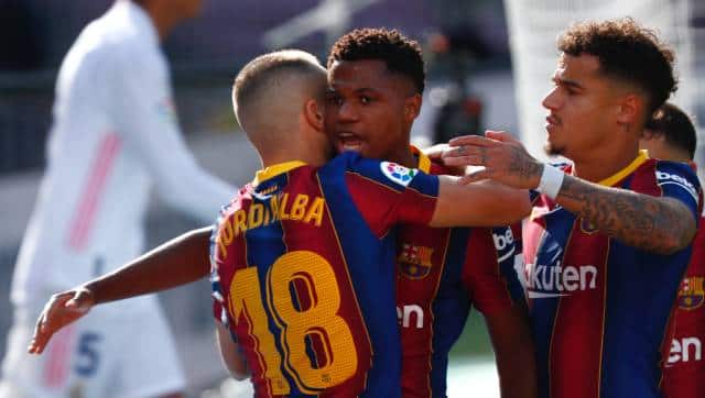 Barcelona's Ansu Fati celebrates with Jordi Alba scoring his side's first goal during the Spanish La Liga soccer match between FC Barcelona and Real Madrid at the Camp Nou stadium in Barcelona, Spain, Saturday, Oct. 24, 2020. (AP Photo/Joan Monfort)