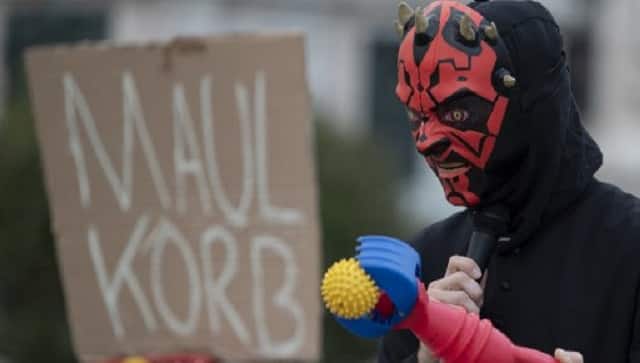 A man dressed with a devil’s costume takes part in a protest against Austrian government’s restrictions implied due to the new coronavirus cases. AFP