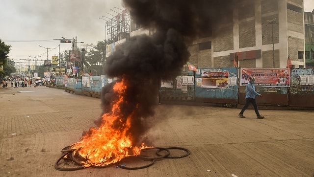 Plumes of smoke rise from tyres set on fire by BJP activists during their march towards State Secretariat Nabanna to protest against 