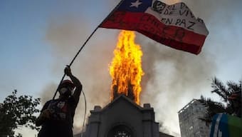 Chile protest anniversary turns violent as two churches torched, thousands gather in Santiago square