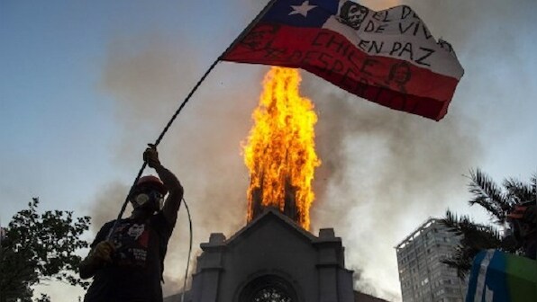 Chile protest anniversary turns violent as two churches torched, thousands gather in Santiago square