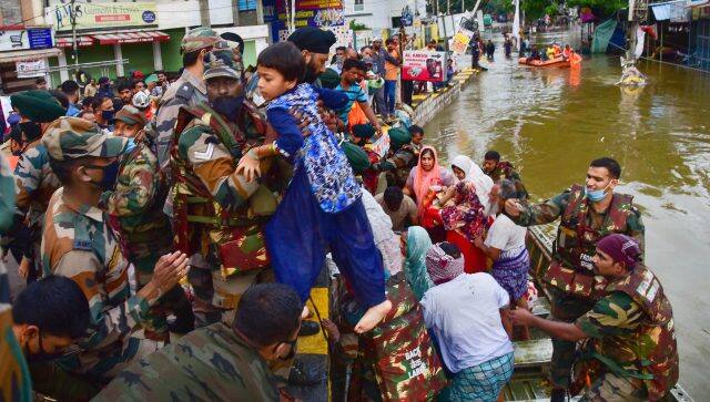 Rescue operation being carried out for locals to move them to safer places following heavy rain at Al Jubail colony in Hyderabad. PTI