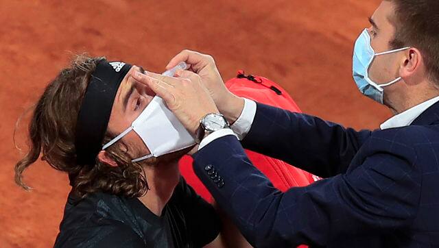 Stefanos Tsitsipas receives medical assistance during his match against Grigor Dimitrov at the French Open on Monday. AP Photo