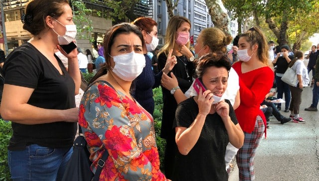 People stand outside their homes in Izmir, Turkey after a strong earthquake in the Aegean Sea has shaken Turkey and Greece. AP