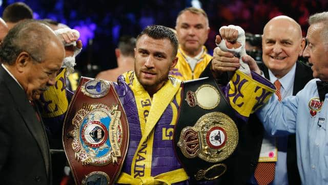 FILE - In this April 12, 2019, file photo, Vasiliy Lomachenko celebrates defending his WBA/WBO lightweight titles after knocking out Anthony Crolla, in Los Angeles. Lomachenko fights Teofimo Lopez on Saturday, Oct. 17, 2020, in Las Vegas. Boxing fans should be thankful. They’re getting a quality fight _ and they’re getting it for free.(AP Photo/Damian Dovarganes, File)