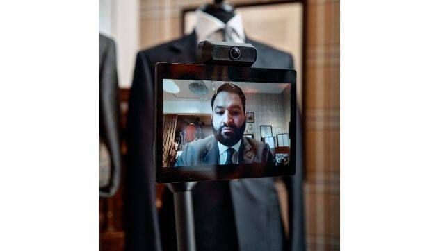 Taj Phull, Huntsman's head of retail, appears on the screen that functions as Mr. Hammick's face at the shop on Savile Row.