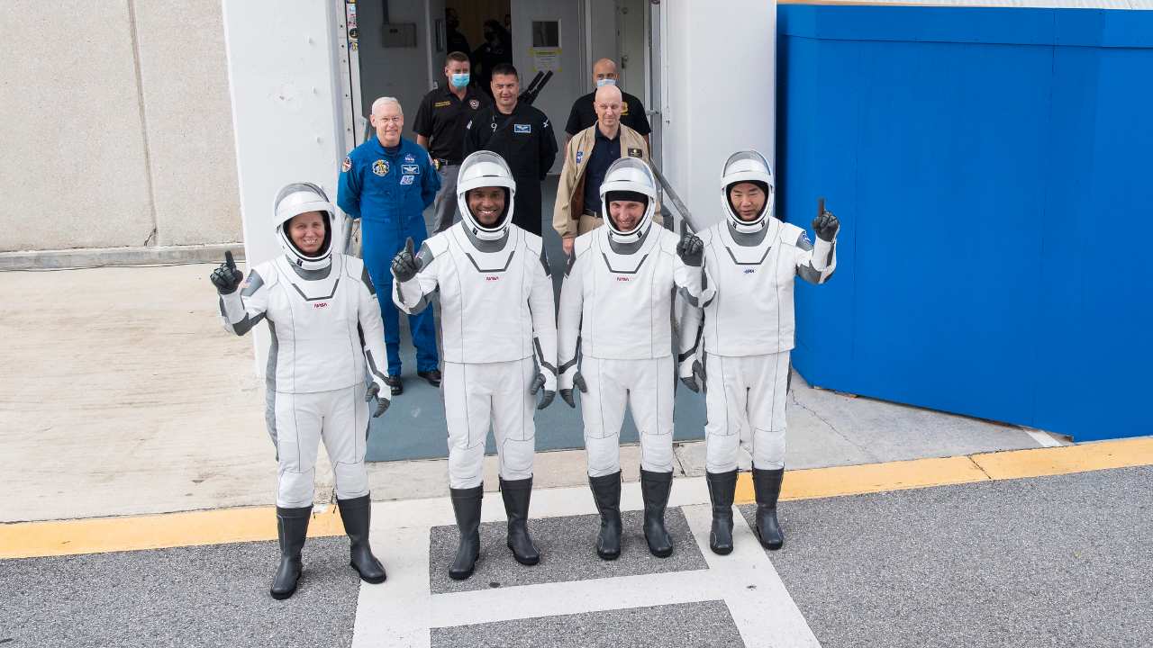 NASA astronauts Shannon Walker, left, Victor Glover, and Mike Hopkins, and Japan Aerospace Exploration Agency (JAXA) astronaut Soichi Noguchi, right, wearing SpaceX spacesuits, stop to pose for a picture as they walk out of the Neil A. Armstrong Operations and Checkout Building to depart for Launch Complex 39A during a dress rehearsal prior to the Crew-1 mission launch, Thursday, Nov. 12, 2020, at NASA’s Kennedy Space Center in Florida. Image Credits: NASA/Joel Kowsky