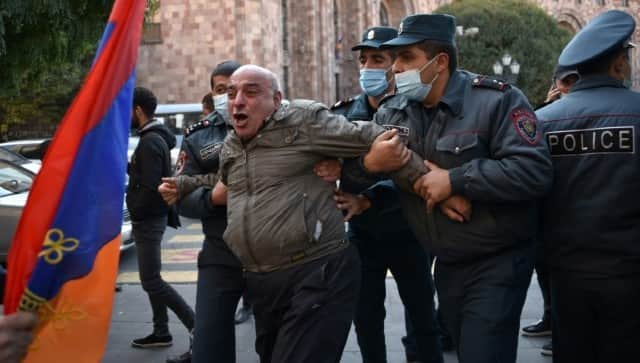 Armenian police officers detain a protestor near the government headquarters. AFP