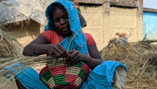 A daily wage labourer from Suryapur Bakiya village near Bettiah weaves a basket during her lunch break from carrying bricks at the nearby brick kiln. Devparna Acharya 