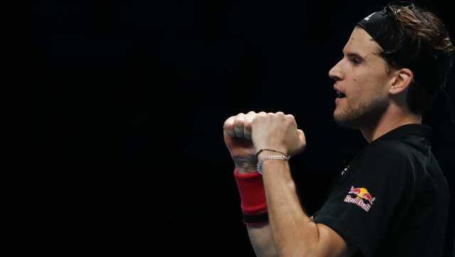 Dominic Thiem of Austria celebrates after winning his semifinal match against Novak Djokovic of Serbia at the ATP World Finals tennis tournament at the O2 arena in London, Saturday, Nov. 21, 2020. (AP Photo/Frank Augstein)