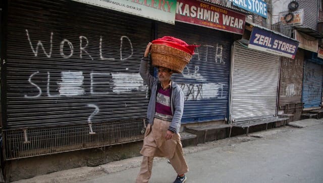 A Kashmiri snacks seller walks at a closed market area during a strike called by separatists in Srinagar. AP