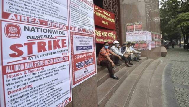 Bank Union members and employees sit outside the main gate of RBI in Kolkata during a nationwide strike called by various central trade unions against farm, farmers laws. PTI
