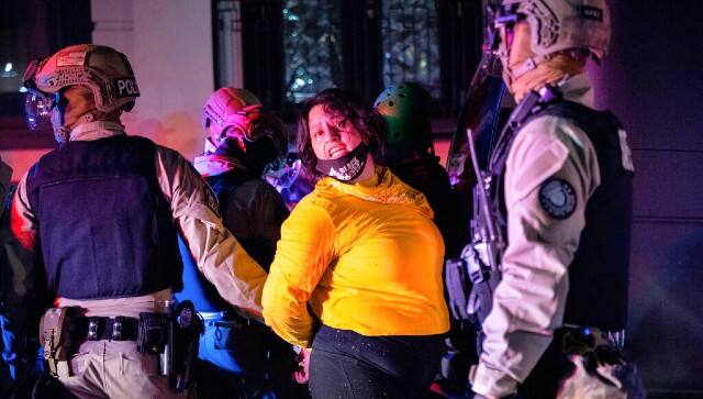 Police arrest a protester as clashes during a march following the presidential election in Portland, Oregon. AP