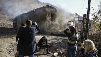 Armenian villagers torch houses before fleeing territory ceded to Azerbaijan