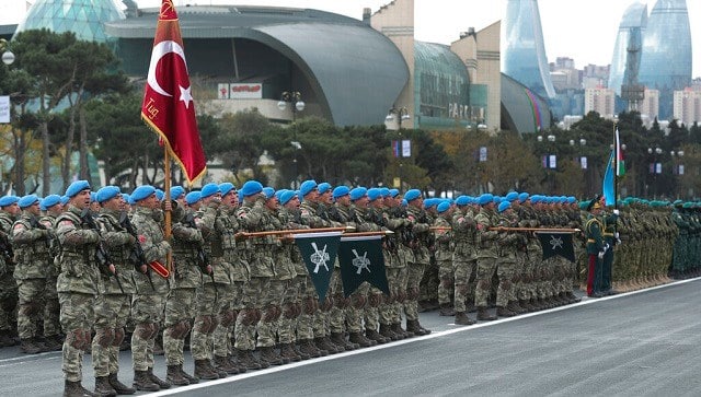 Members of a Turkish forces commando brigade take part in a military parade in Baku, Azerbaijan on Thursday. The massive parade was held in celebration of the peace deal with Armenia over Nagorno-Karabakh that saw Azerbaijan reclaim much of the separatist region along with surrounding areas. (Turkish Presidency via AP, Pool)